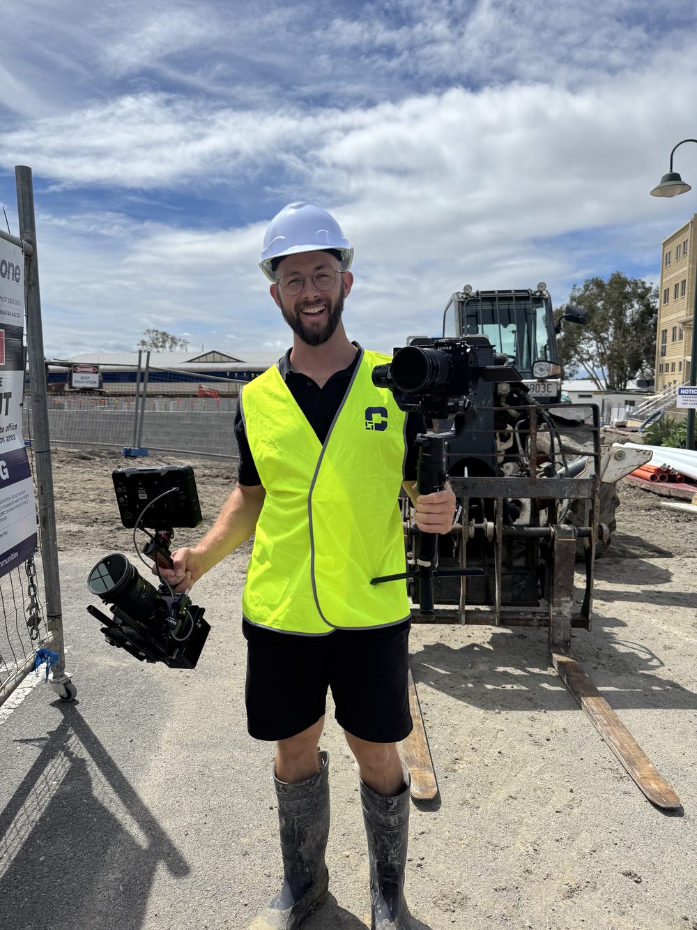 Adam on a construction site with a gimbal rig